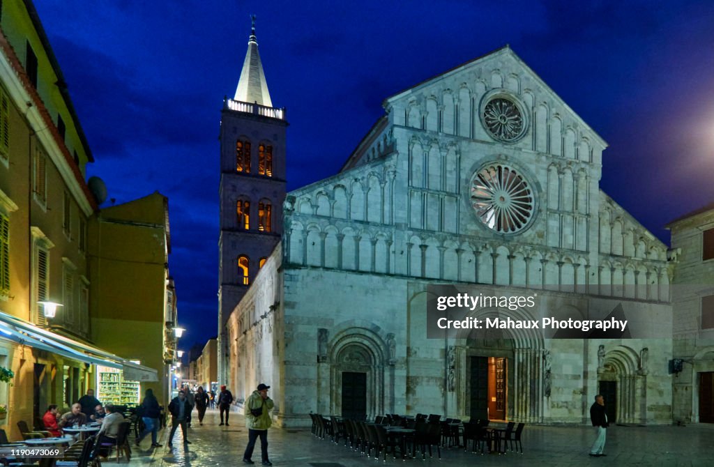 The facade of the catedral of St Anastasia  and its bell tower illuminated in Zadar