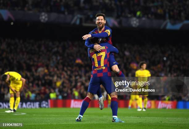 Antoine Griezmann of FC Barcelona celebrates with teammate Lionel Messi after scoring his team's third goal during the UEFA Champions League group F...