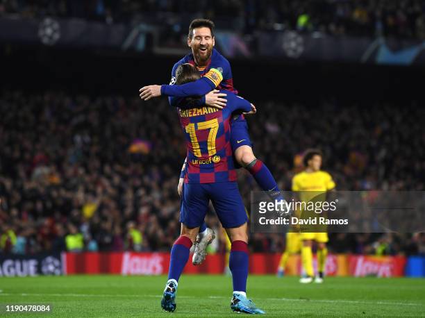 Antoine Griezmann of FC Barcelona celebrates with teammate Lionel Messi after scoring his team's third goal during the UEFA Champions League group F...