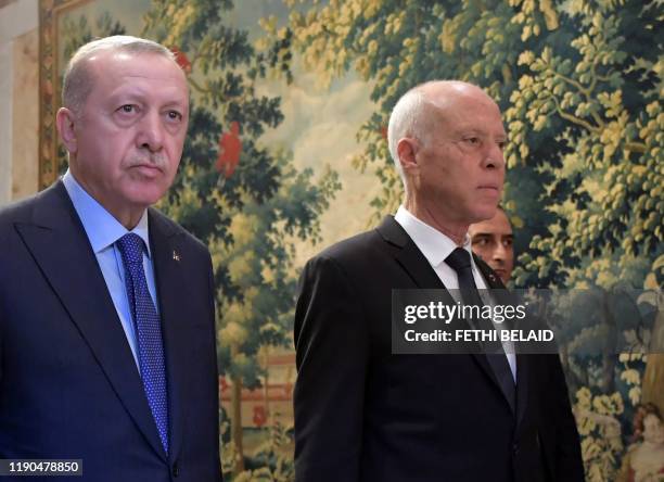 Tunisian President Kais Saied arrives with Turkish President Recep Tayyip Erdogan for a joint press conference at the presidential palace in...