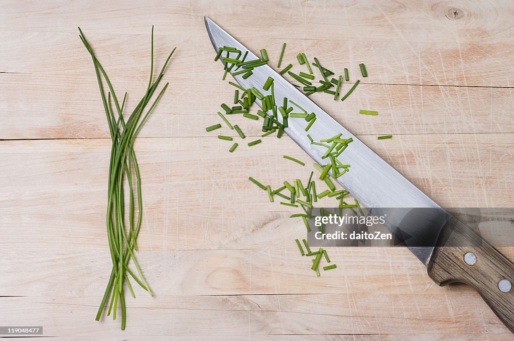 Green chives on cutting board