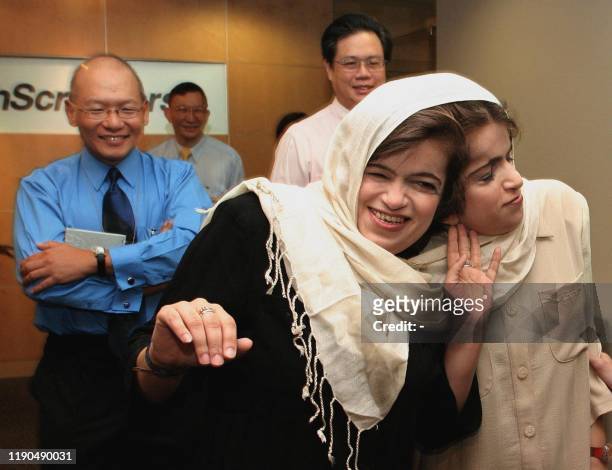 This file photo dated 11 June 2003 shows the late Iranian twins Ladan and Laleh Bijani giving a press conference at Raffles Hospital in Singapore as...