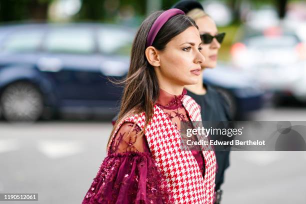 Guest wears a purple head band, a hi-neck puff sleeves burgundy tulle top with glittering embroideries, a white and red houndstooth V-neck jumper ,...