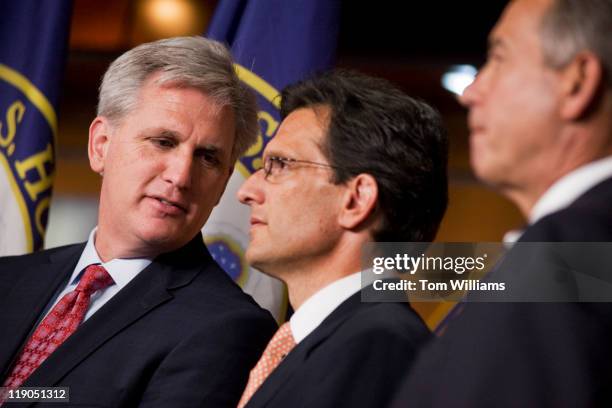 House Majority Whip Kevin McCarthy, R-Calif., left, has a word with House Majority Leader Eric Cantor, R-Va., as Speaker John Boehner, R-Ohio, looks...