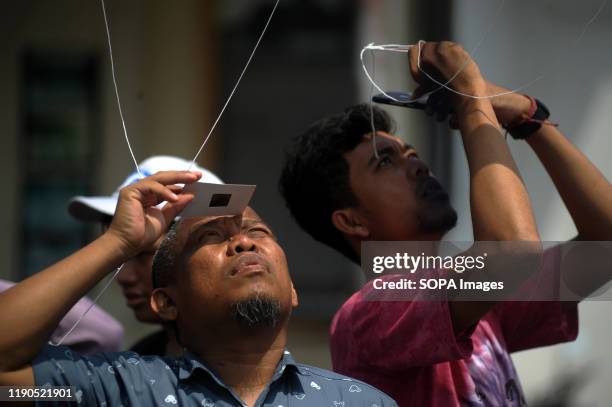 Indonesians use special lenses to watch the phenomenon of the "ring of fire" solar eclipse. Ring solar eclipse was viewed in different regions in...