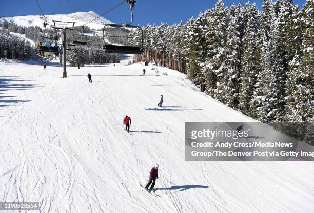 Skiers and snowboarders head down to the Rocky Mountain Super Chair lift on Peak 8 at the Breckenridge Ski resort November 23, 2019.