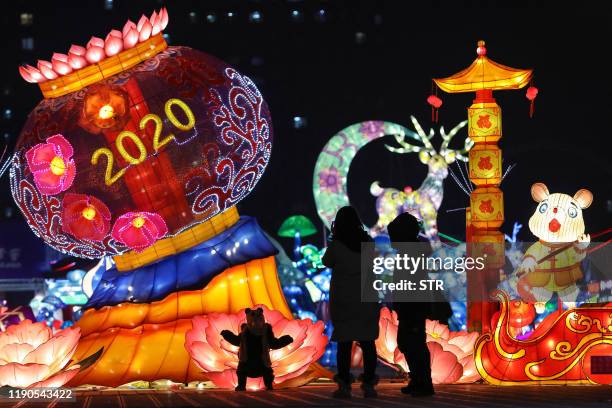 This photo taken on December 26, 2019 shows people visiting a lantern show ahead of the 2020 new year in Shenyang, China's northeastern Liaoning...