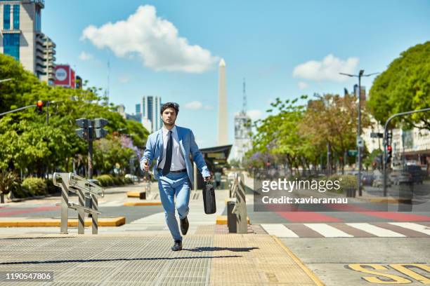 jonge zakenman met aktetas lopende naar afspraak - naderen stockfoto's en -beelden