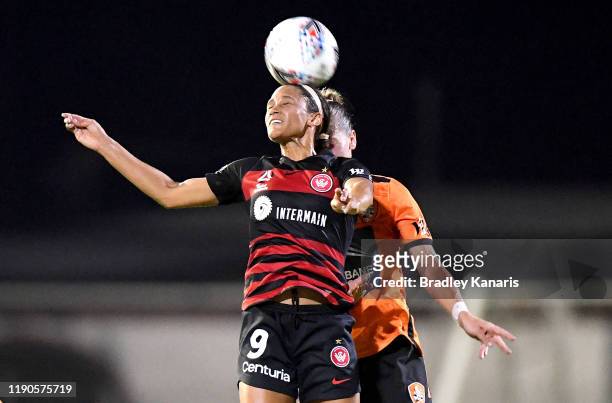 Lynn Williams of the Wanderers and Celeste Boureille of the Roar challenge for the ball during the round three W-League match between the Brisbane...