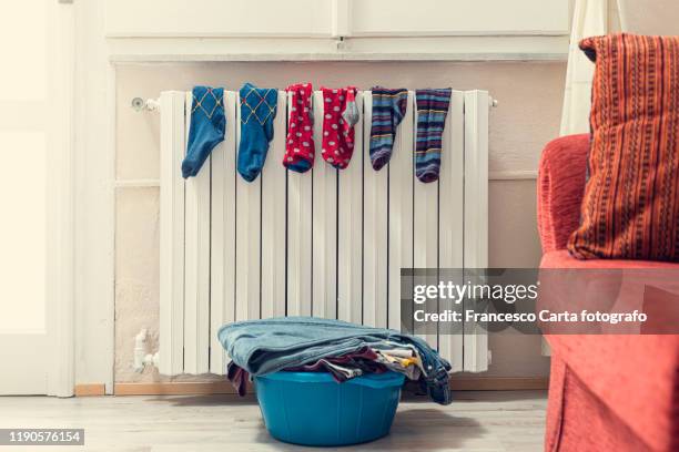 socks on radiator - wet jeans stock-fotos und bilder