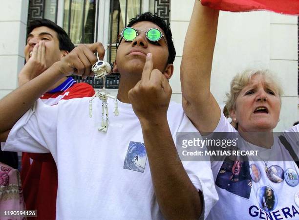 Group of Pinochet supporters shout slogan in favor of former Chilean dictator Augusto Pinochet outside of the Justice Court of Santiago, Chile, 07...