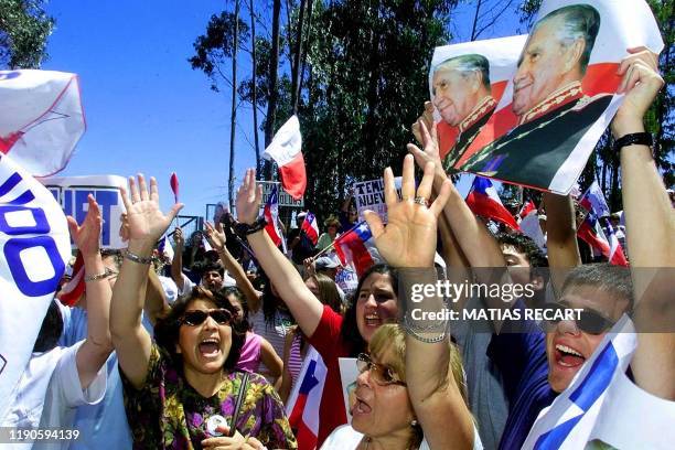 Group of supporters shouts slogans in support of former dictator Augusto Pinochet, outside of Los Bolodos, Bucalemu, where he is staying 30 January...