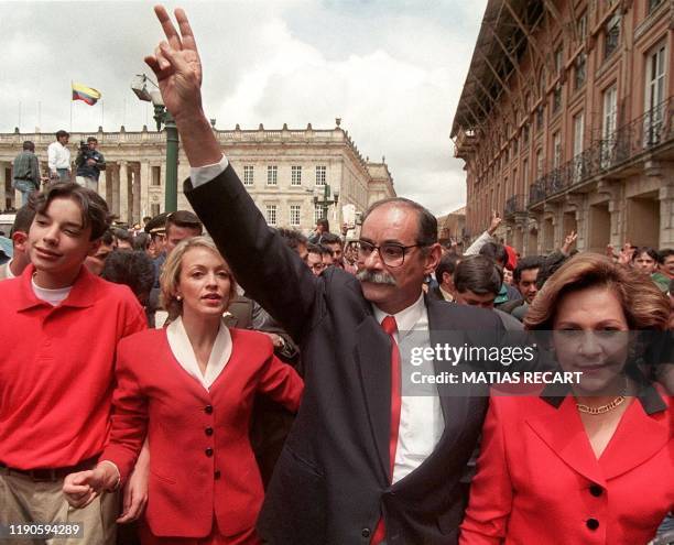 Liberal presidential candidate Horacio Serpa greets supporters, accompanied by his wife Rosita and running mate Maria Emma Mejia after casting his...