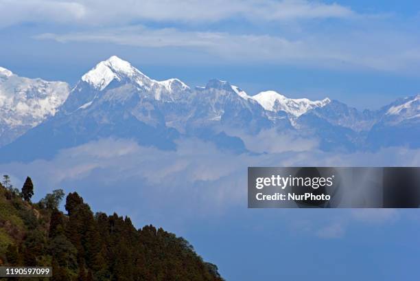 Snow peak Kangchenjunga mountain range can be seen in a hilly place of North Bengal, India, 24 December, 2019.