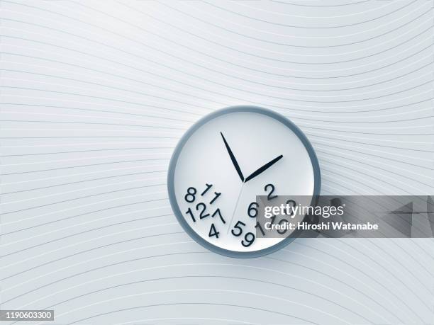 a clock with numbers falling from the face  on the wall with wave pattern - killing time stock pictures, royalty-free photos & images