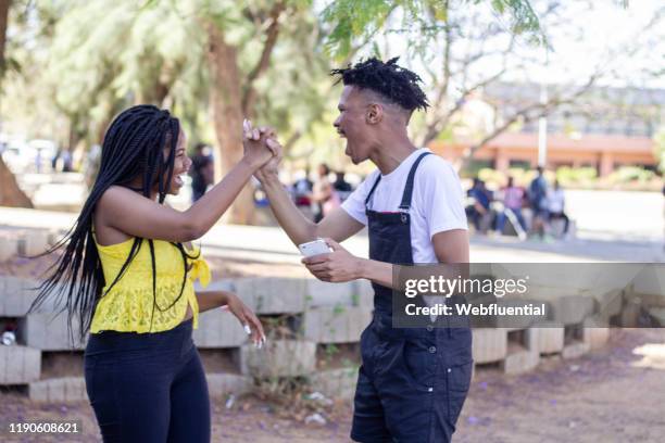 african couple high five - webfluential bildbanksfoton och bilder