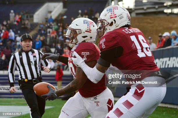 Running back Re'Mahn Davis of the Temple Owls celebrates with quarterback Todd Centeio after scoring a touchdown in the second half against the North...