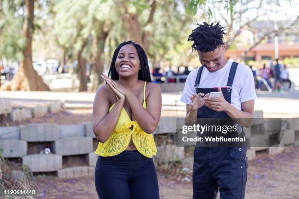 african couple high five - webfluential bildbanksfoton och bilder
