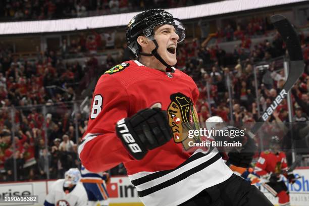 Dominik Kubalik of the Chicago Blackhawks reacts after scoring against the New York Islanders in the first period at the United Center on December...