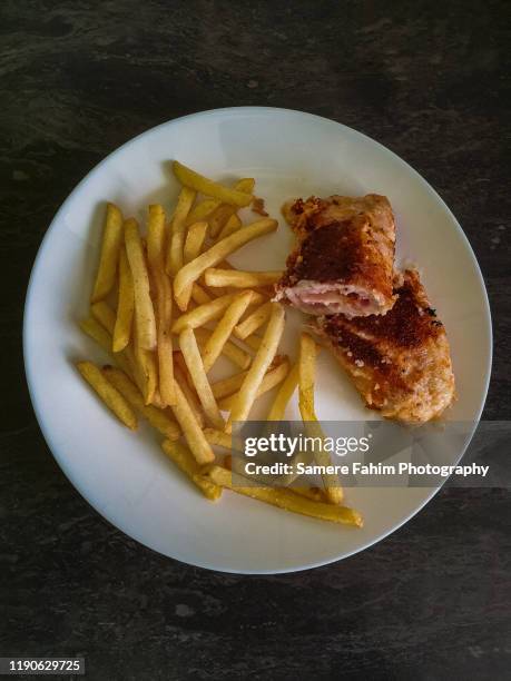 close-up of cordon bleu and french fries on plate - cordon bleu stock-fotos und bilder