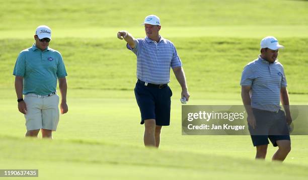 Richard Sterne of South Africa , Ernie Els of South Africa and George Coetzee of South Africa walk down the fairway in shorts during Day One of the...