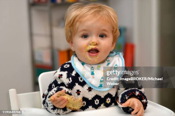 toddler eating, 1 year, mouth smeared, portrait, baden-wuerttemberg, germany - baby bib stock pictures, royalty-free photos & images