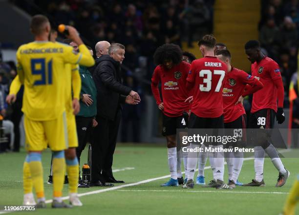 Manager Ole Gunnar Solskjaer of Manchester United speaks to Tahith Chong and James Garner during the UEFA Europa League group L match between FK...