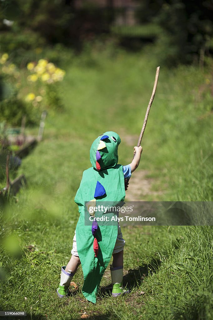 Child playing outdoors in fancy dress