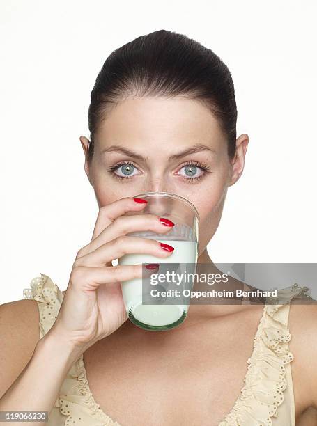 young female drinking glass of milk - drink milk foto e immagini stock