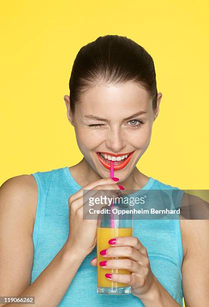 young female drinking and winking - straw lips stock pictures, royalty-free photos & images