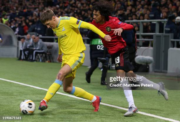 Mani Bughail-Mellor of Manchester United in action with Yevgeny Postnikov of FK Astana during the UEFA Europa League group L match between FK Astana...