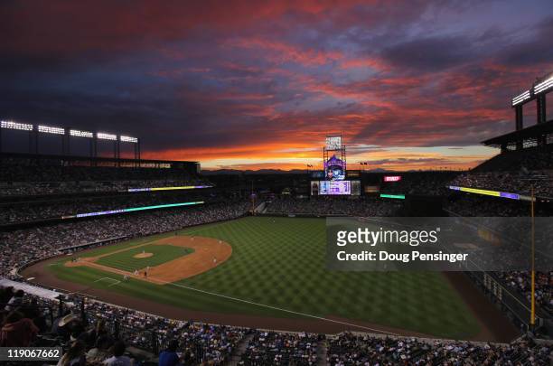 The sun sets over the stadium as the Milwaukee Brewers face the Colorado Rockies at Coors Field on July 14, 2011 in Denver, Colorado.