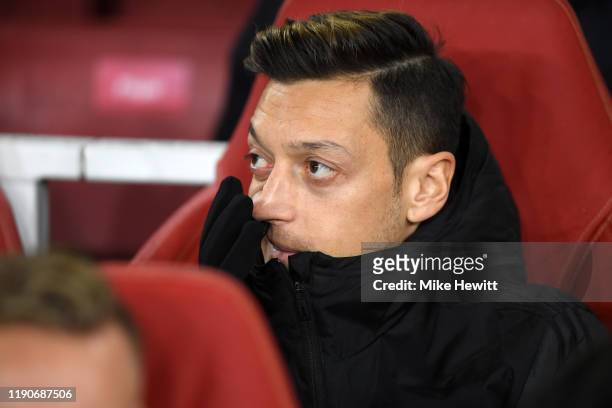 Mesut Ozil of Arsenal looks on from the substitute bench ahead of the UEFA Europa League group F match between Arsenal FC and Eintracht Frankfurt at...