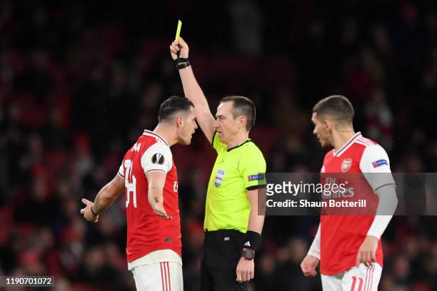 Granit Xhaka of Arsenal is shown a yellow card by referee Ruddy Buquet during the UEFA Europa League group F match between Arsenal FC and Eintracht...