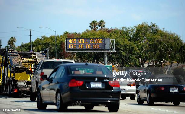 Traffic signs alerts motorists on Interstate 405 of the shutdown one day before workers start demolishing the Mulholland Bridge on Interstate 405 at...
