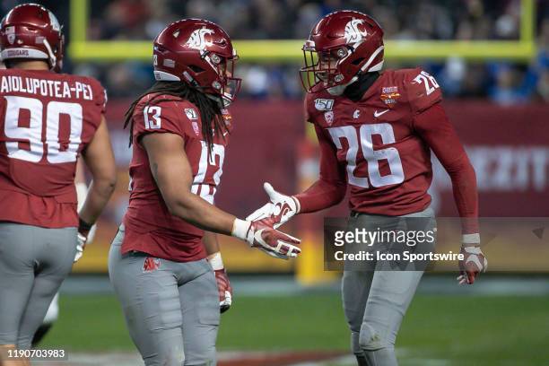 Washington State Cougars linebacker Jahad Woods and Washington State Cougars safety Bryce Beekman react to a big play during the Cheez-It Bowl...