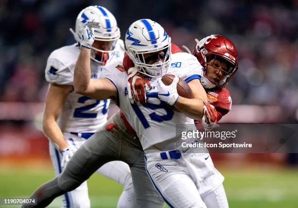 Air Force Falcons running back Nolan Eriksen gets wrapped up by Washington State Cougars safety Bryce Beekman during the Cheez-It Bowl college...