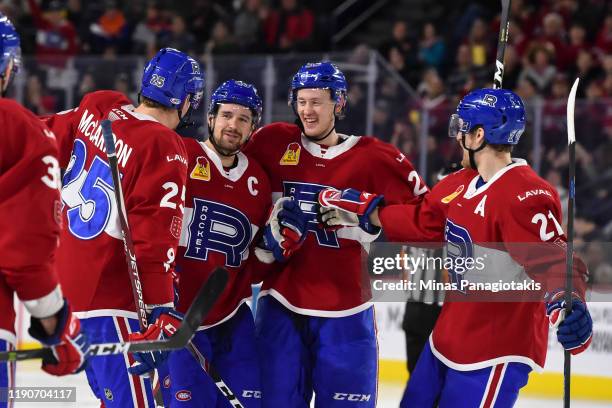 Xavier Ouellet of the Laval Rocket celebrates his goal with teammates Michael McCarron, Gustav Olofsson and Dale Weise during the second period...