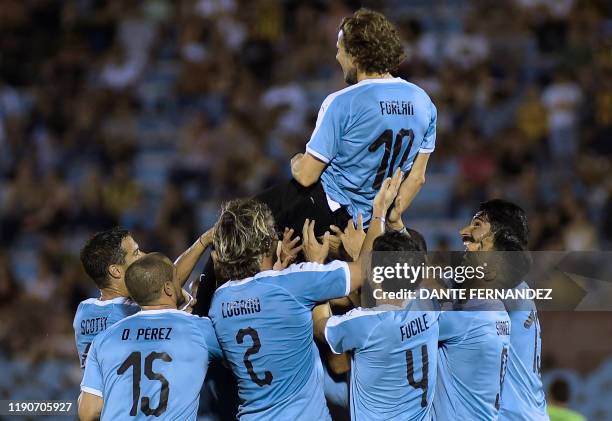 Uruguayan ex-football star Diego Forlan's former teammates in the national team Andres Scotti, Diego Perez, Diego Lugano, Jorge Fucile, Luis Suarez...