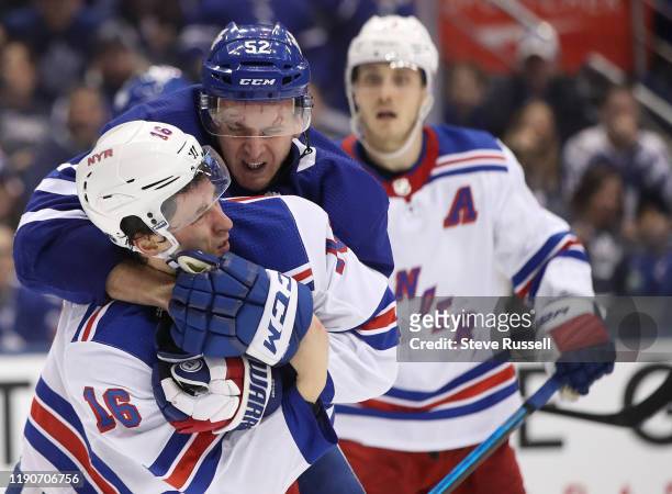 Toronto Maple Leafs defenseman Martin Marincin and New York Rangers center Ryan Strome wrestle after a whistle as the Toronto Maple Leafs play the...