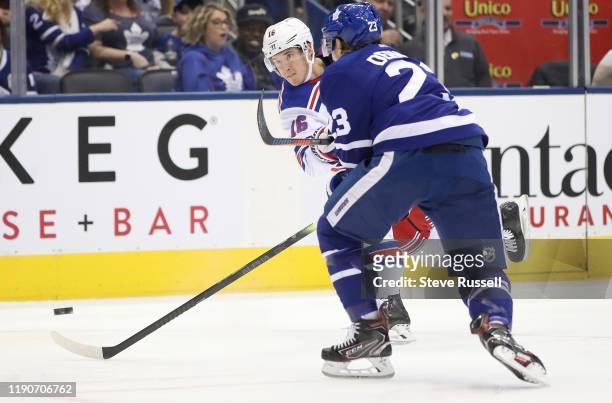 New York Rangers center Ryan Strome fires a shot past Toronto Maple Leafs defenseman Travis Dermott to score as the Toronto Maple Leafs play the New...