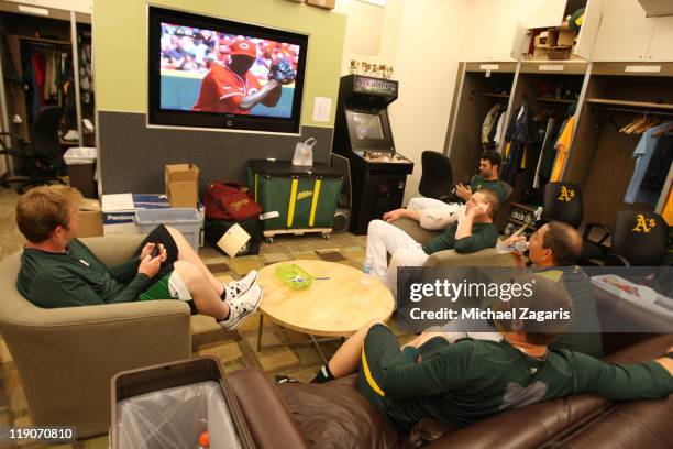 Brett Anderson, Cliff Pennington, Brian Fuentes, Trevor Cahill and Conor Jackson of the Oakland Athletics watch a baseball game on TV before the game...