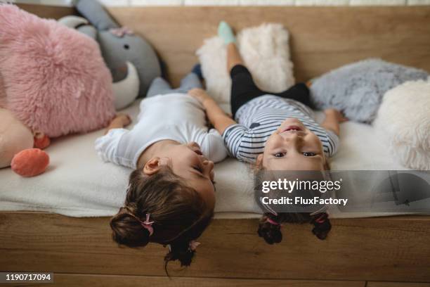 two young girls laying on the couch upside down - girl looking down stock pictures, royalty-free photos & images