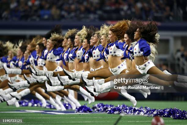 The Dallas Cowboys Cheerleaders jump while performing at AT&T Stadium on November 28, 2019 in Arlington, Texas.