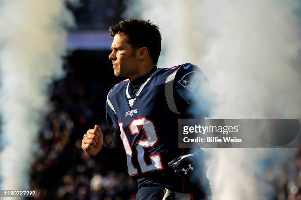 Tom Brady of the New England Patriots runs onto the field before a game against the Miami Dolphins at Gillette Stadium on December 29, 2019 in...
