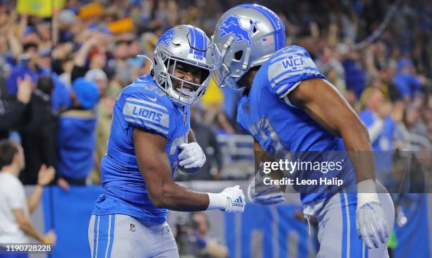 Kerryon Johnson of the Detroit Lions scores a touchdown and celebrates with teammate Jason Cabinda during the second quarter of the game against the...