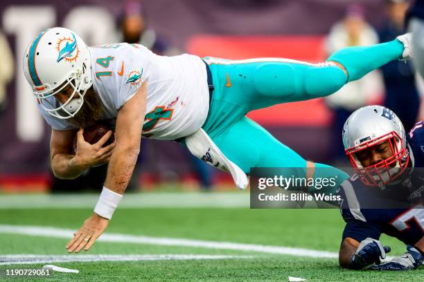 Ryan Fitzpatrick of the Miami Dolphins carries the ball for a touchdown during the third quarter of a game against the New England Patriots at...