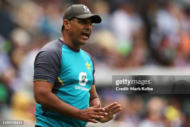 Pakistan coach Waqar Younis speaks to Mohammad Abbas of Pakistan on the boundary during play on day one of the 2nd Domain Test between Australia and...