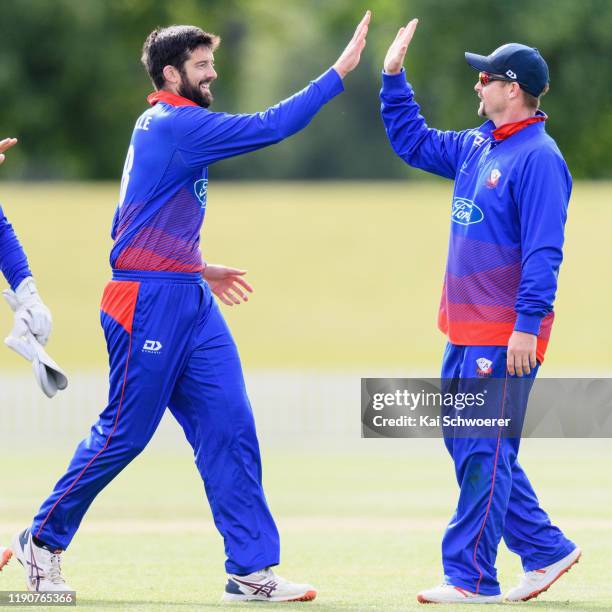 Will Somerville of Auckland is congratulated by Colin Munro of Auckland after dismissing Jack Boyle of Canterbury during the Ford Trophy match...