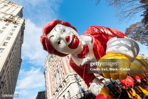 Ronald McDonald ballon battles the high wind to fly down Central Park West past apartments during the 93rd Annual Macy's Thanksgiving Day Parade. The...